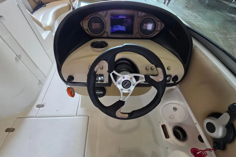 Slide: The Image of Steering console of a 2012 SouthWind 2400 SD boat with navigation display. - 26