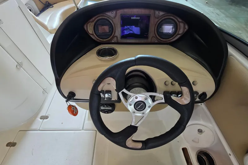 Slide: The Image of Steering console of a 2012 SouthWind 2400 SD boat with navigation display. - 28