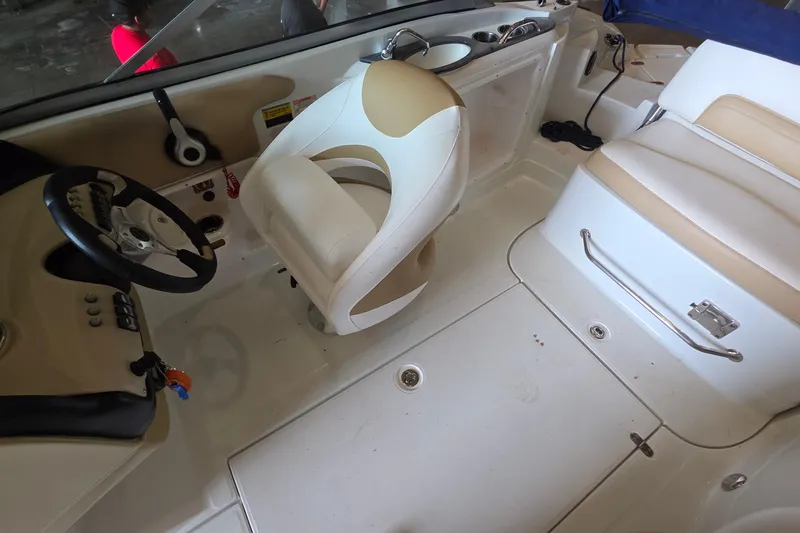 Slide: The Image of Interior of a 2012 SouthWind 2400 SD boat, featuring steering wheel and seating. - 31