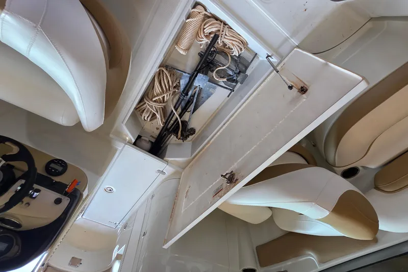 Slide: The Image of Interior of a 2012 SouthWind 2400 SD boat showing storage compartment with ropes. - 34