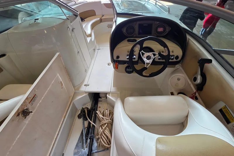 Slide: The Image of Interior view of a 2012 SouthWind 2400 SD boat, featuring steering wheel and seating. - 35