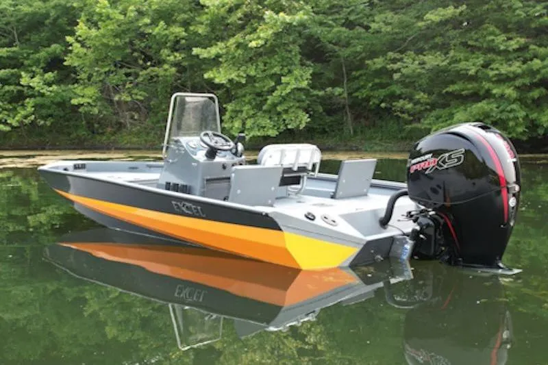 Slide: The Image of 2026 Excel 203 Bay Pro Elite boat on calm water, surrounded by lush greenery. - 5