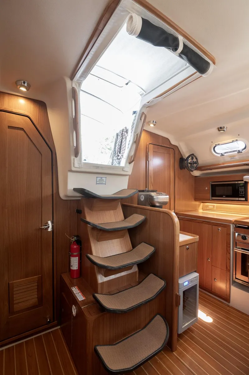 Slide: The Image of 2024 Catalina 445 yacht interior with wooden stairs and modern kitchen amenities. - 18