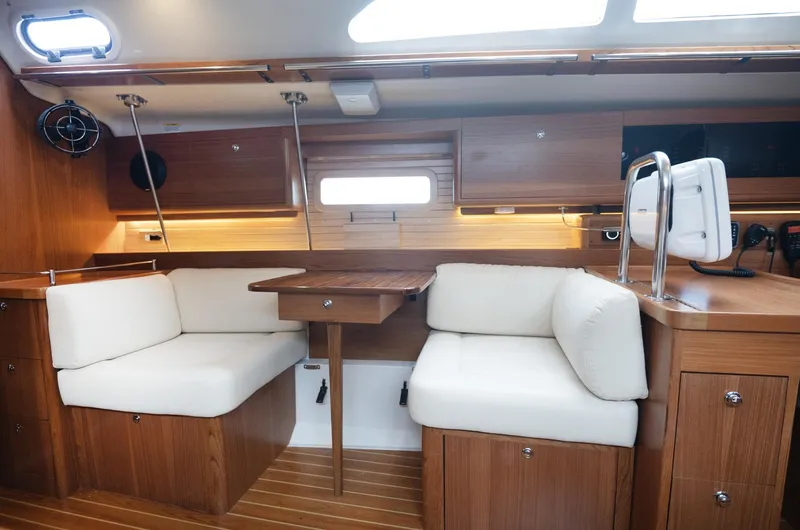 Slide: The Image of Luxurious interior of 2024 Catalina 445 sailboat with wooden furnishings and white seating. - 4