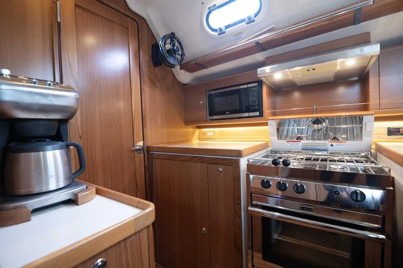 Slide: The Image of 2024 Catalina 445 yacht kitchen with stove, microwave, and coffee maker. - 8