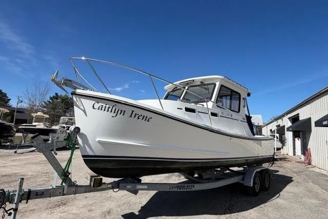 The Image of 2020 Eastern 248 Explorer boat on trailer under clear blue sky. - 1