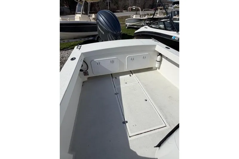 Slide: The Image of 2020 Eastern 248 Explorer boat deck with storage compartments and clean layout. - 10