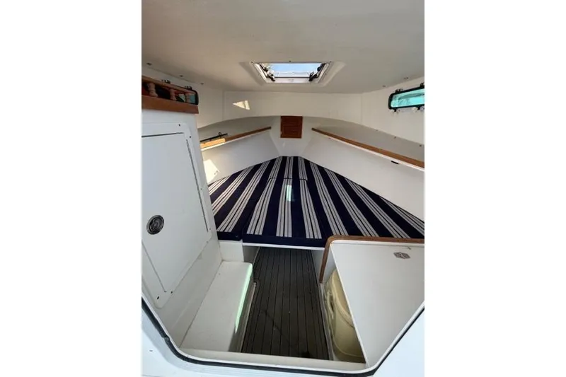 Slide: The Image of Interior cabin of 2020 Eastern 248 Explorer boat with striped bedding. - 5