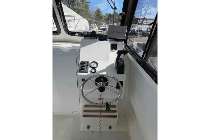 Slide: The Image of Helm of 2020 Eastern 248 Explorer boat with Garmin navigation system and steering wheel. - 7