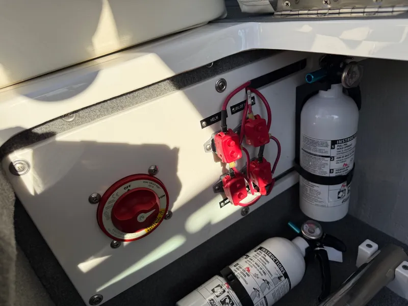 Slide: The Image of Cobalt R7 2015 boat electrical panel and fire extinguishers in storage. - 33