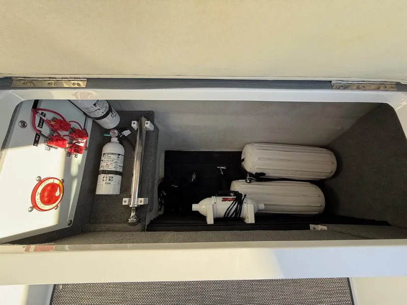 Slide: The Image of Storage compartment in Cobalt R7 boat with safety equipment, year 2015. - 34