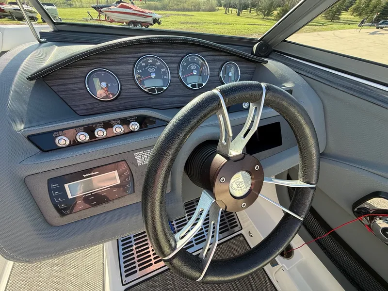 Slide: The Image of Steering wheel and dashboard of a 2015 Cobalt R7 boat. - 36