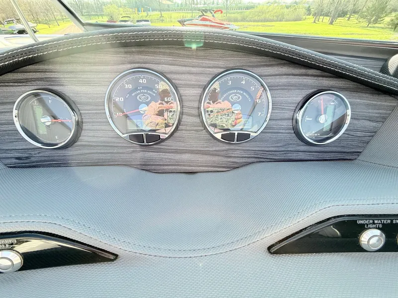 Slide: The Image of Dashboard of a 2015 Cobalt R7 boat with gauges. - 37