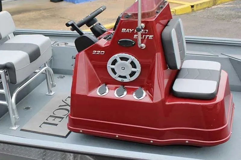 Slide: The Image of 2026 Excel 220 Bay Pro Elite boat interior with red console and seating. - 3