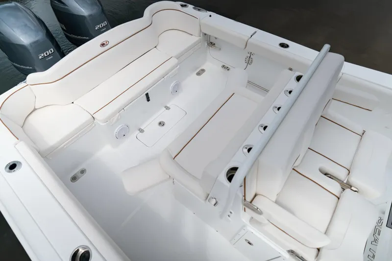 Slide: The Image of 2021 Sea Hunt Ultra 275 SE boat with spacious seating and dual engines on a serene lake. - 13