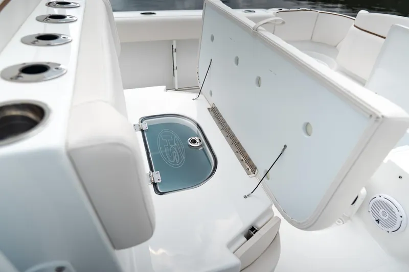 Slide: The Image of Anchor compartment of 2021 Sea Hunt Ultra 275 SE boat, featuring chain and winch. - 16
