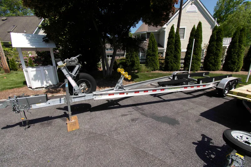 Slide: The Image of Boat trailer for 2021 Sea Hunt Ultra 275 SE parked on driveway. - 18