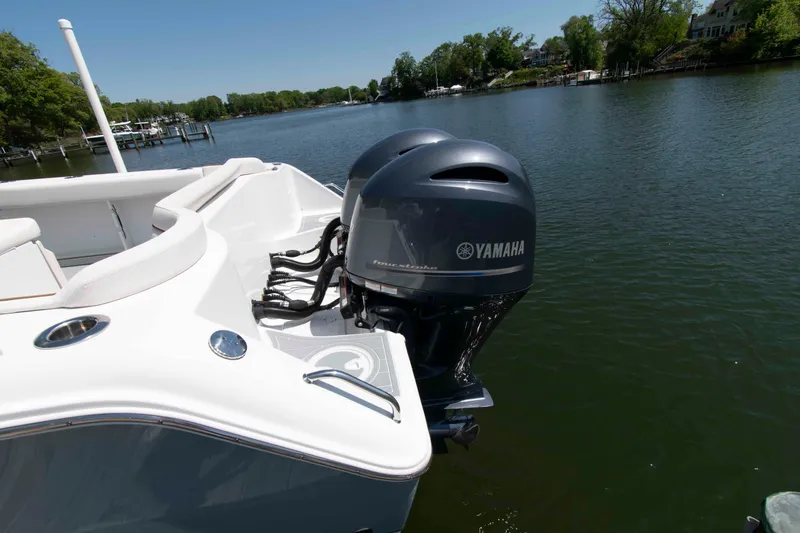 Slide: The Image of 2021 Sea Hunt Ultra 275 SE boat with Yamaha engines on a serene lake. - 20