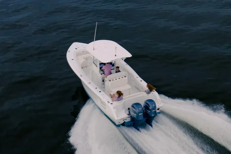 Slide: The Image of 2021 Sea Hunt Ultra 275 SE boat on a Venture trailer, parked on grass. - 3