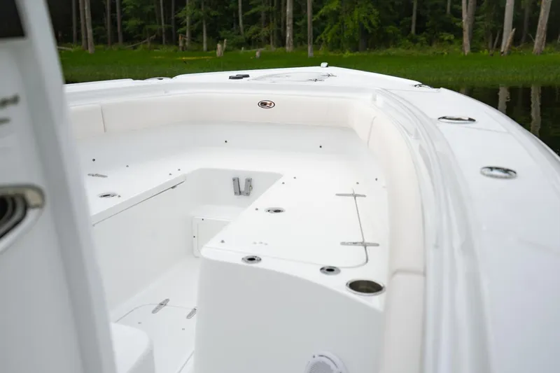 Slide: The Image of 2021 Sea Hunt Ultra 275 SE boat with covered console, displayed outdoors. - 7