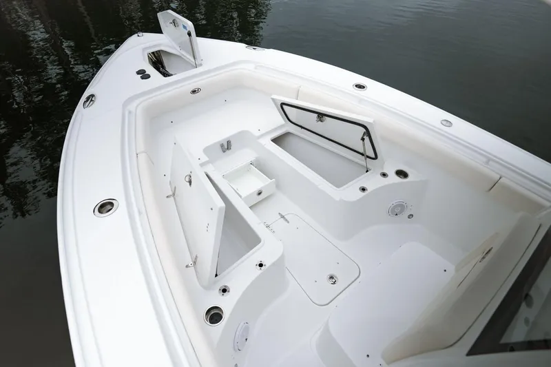 Slide: The Image of 2021 Sea Hunt Ultra 275 SE boat interior with seating and console, displayed outdoors. - 8