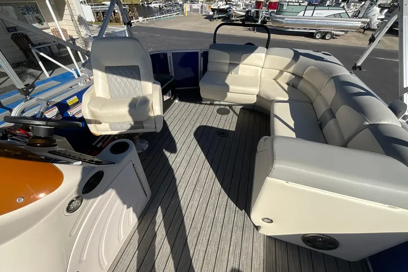 Slide: The Image of 2021 Lexington 318 3 Series boat interior with plush seating and steering console. - 11