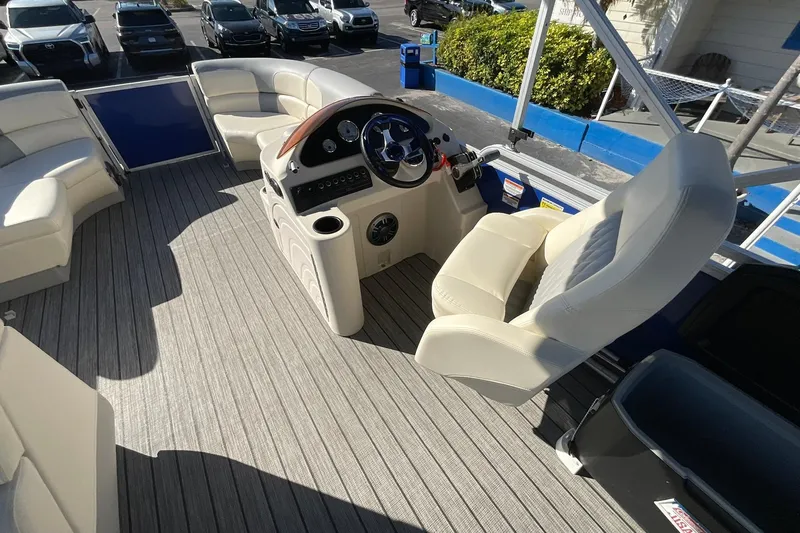 Slide: The Image of 2021 Lexington 318 3 Series boat interior with plush seating and modern helm controls. - 13