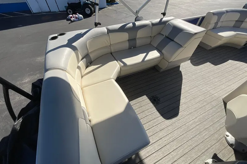 Slide: The Image of Luxurious seating on a 2021 Lexington 318 3 Series pontoon boat, featuring plush cream upholstery. - 15