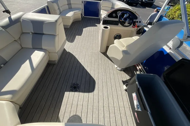 Slide: The Image of Interior of a 2021 Lexington 318 3 Series pontoon boat with plush seating and steering console. - 16