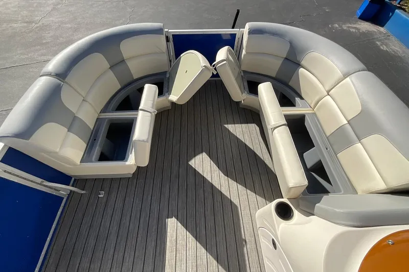Slide: The Image of 2021 Lexington 318 3 Series boat interior with gray and beige seating, open storage compartments. - 17