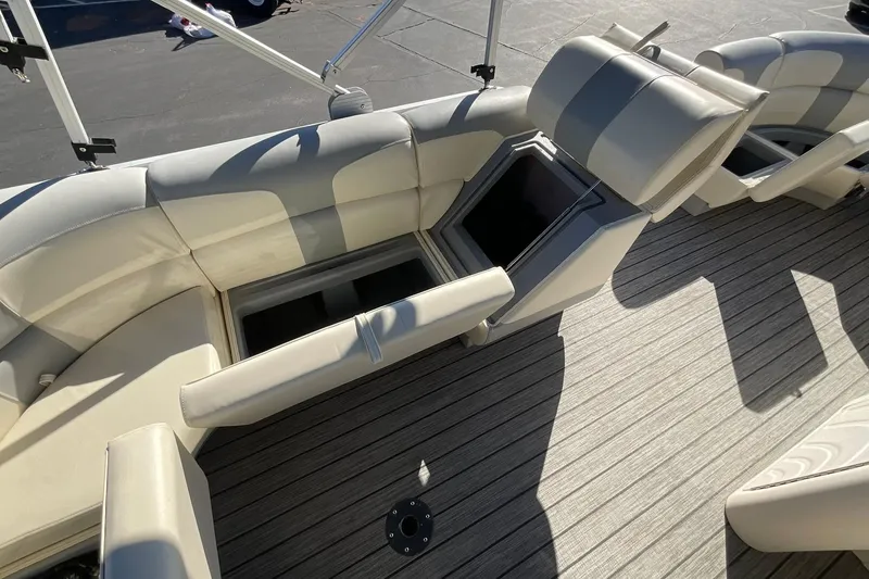 Slide: The Image of Interior of 2021 Lexington 318 3 Series boat with open storage compartments and cushioned seating. - 18