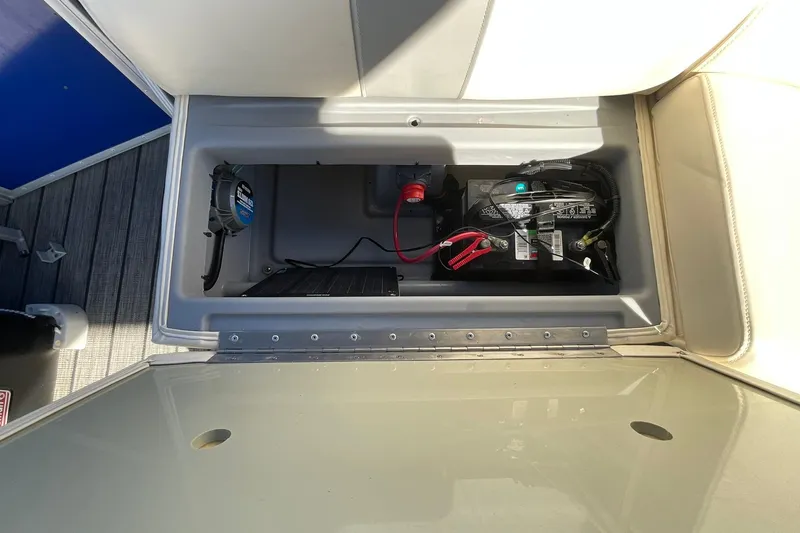 Slide: The Image of Battery compartment of a 2021 Lexington 318 3 Series boat, showing wiring and connections. - 19