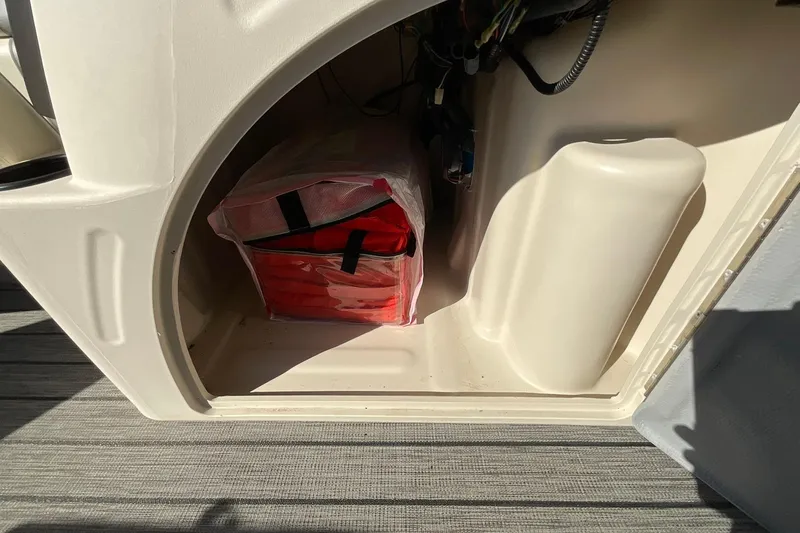 Slide: The Image of Storage compartment in a 2021 Lexington 318 3 Series boat with safety equipment. - 21