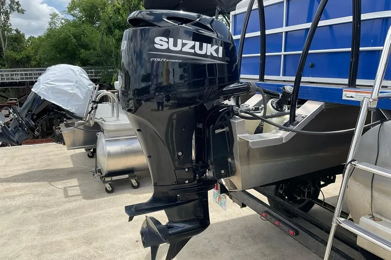 Slide: The Image of Outboard motor on a 2021 Lexington 318 3 series boat, parked on a trailer. - 6