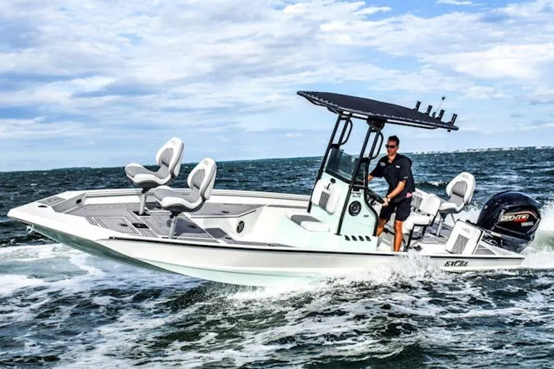 Slide: The Image of 2026 Excel 230 Bay Pro Elite boat cruising on open water under a clear sky. - 3