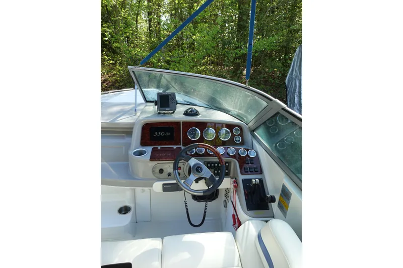 Slide: The Image of 2002 Formula 330 Sun Sport boat dashboard with steering wheel and gauges. - 12