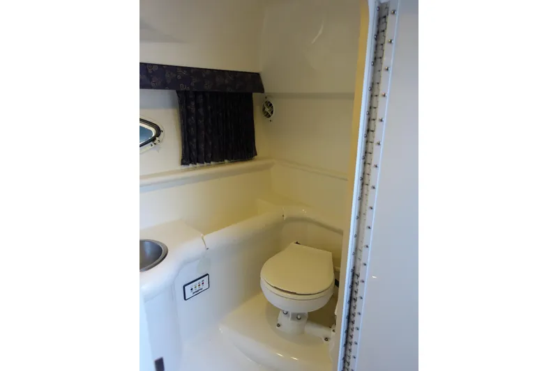 Slide: The Image of 2002 Formula 330 Sun Sport boat bathroom with toilet and sink. - 16