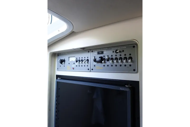 Slide: The Image of Control panel and refrigerator inside a 2002 Formula 330 Sun Sport boat. - 17