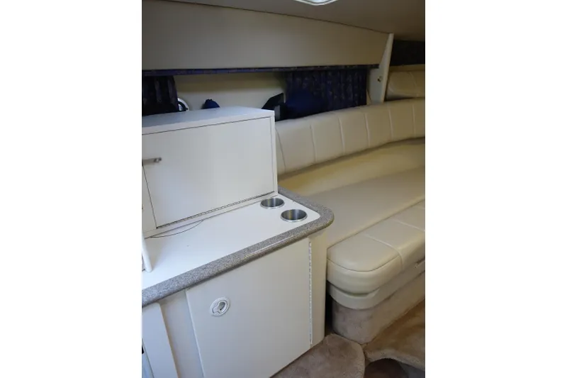 Slide: The Image of Interior of 2002 Formula 330 Sun Sport boat with beige seating and compact kitchenette. - 21