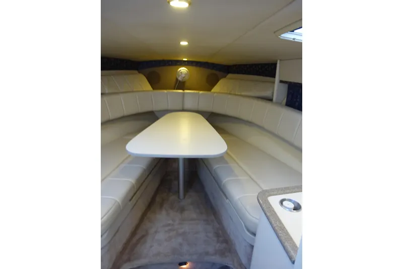 Slide: The Image of Interior of 2002 Formula 330 Sun Sport boat with white seating and table. - 22
