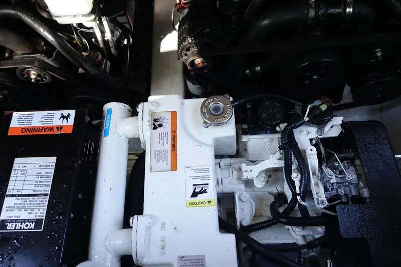 Slide: The Image of Engine compartment of a 2002 Formula 330 Sun Sport boat, featuring mechanical components. - 25