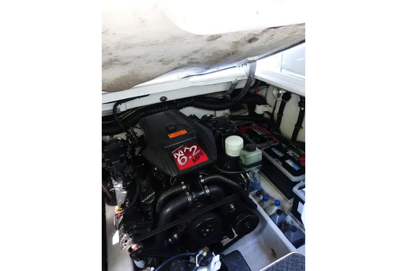Slide: The Image of Engine compartment of a 2002 Formula 330 Sun Sport boat, featuring a MerCruiser MX 6.2 MPI engine. - 27