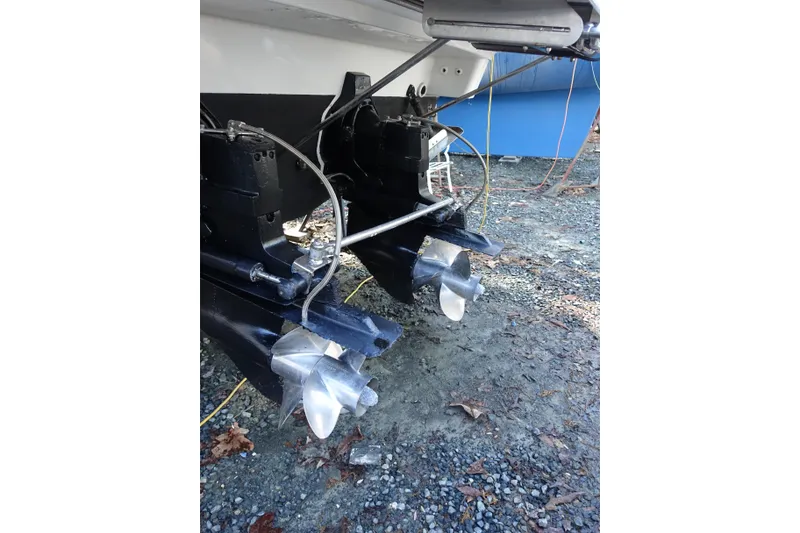 Slide: The Image of 2002 Formula 330 Sun Sport boat propellers on gravel surface. - 31