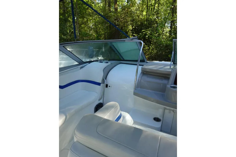 Slide: The Image of 2002 Formula 330 Sun Sport boat interior with white seating and blue accents. - 8