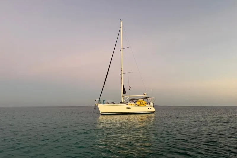The Image of Sailboat Hunter 410 (2002) on calm sea at sunset. - 0