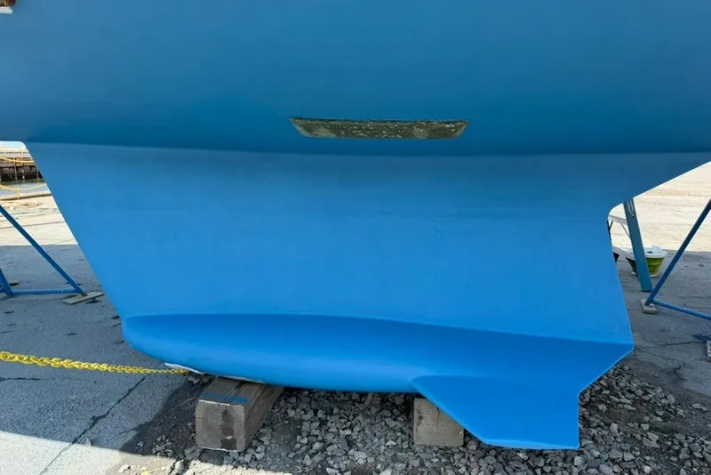 Slide: The Image of Blue hull of a 2002 Hunter 410 sailboat on dry dock. - 14
