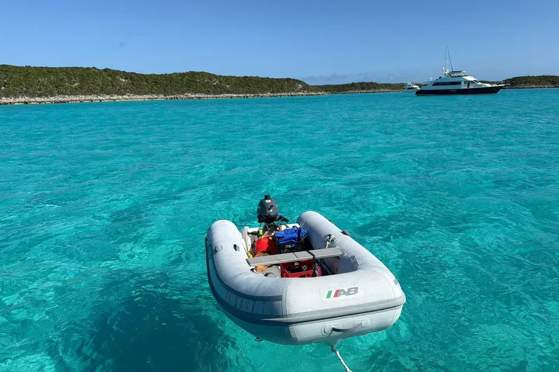 Slide: The Image of Inflatable boat on clear turquoise water with distant yacht, Hunter 410 model, 2002. - 16