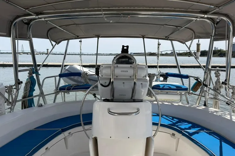 Slide: The Image of Cockpit of 2002 Hunter 410 sailboat with Yamaha steering, docked by the water. - 19