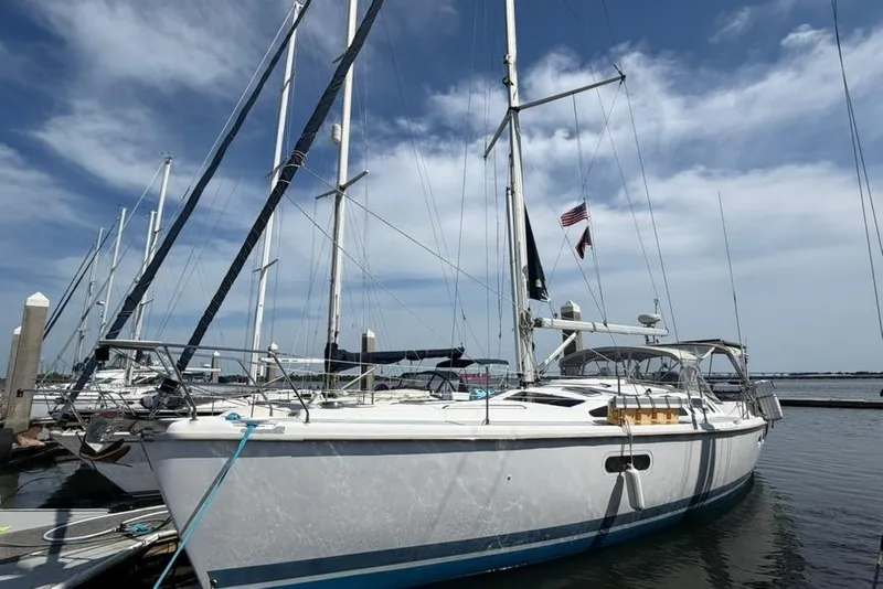 Slide: The Image of Sailboat docked at marina, 2002 Hunter 410 model under clear blue sky. - 2