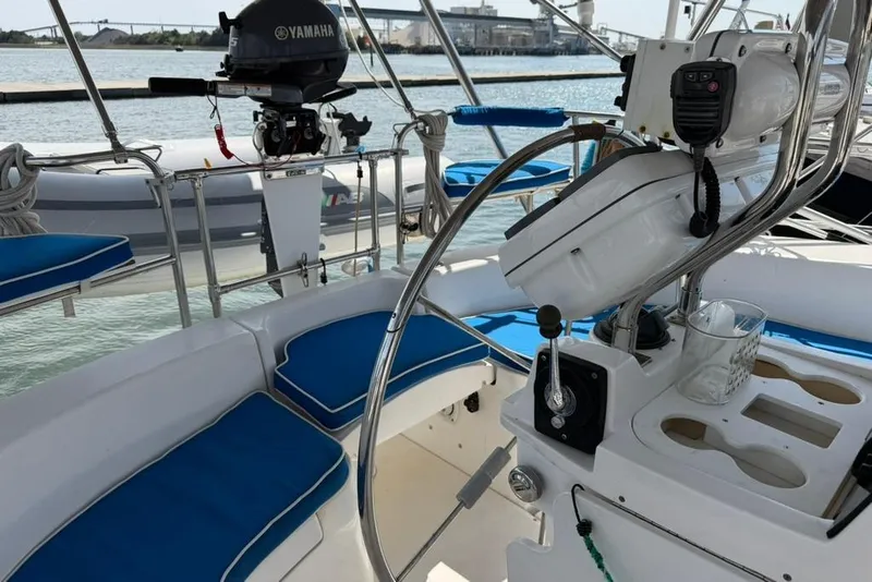Slide: The Image of Cockpit of a 2002 Hunter 410 sailboat with blue cushions and Yamaha outboard motor. - 23